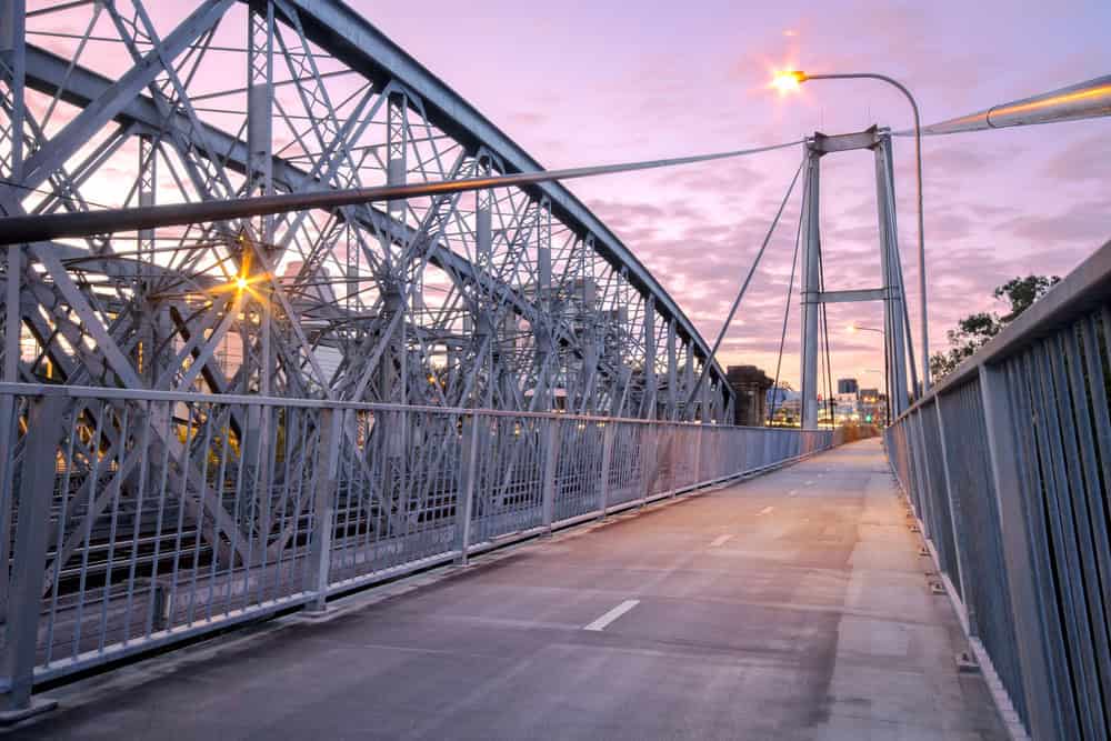 Steel bridge walkway during sunset in Australia.