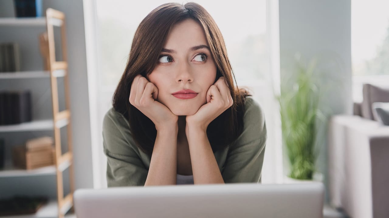 Thoughtful lawyer evaluating the downsides of using Squarespace, with a contemplative expression and hands touching cheeks, symbolising the critical decision-making in web design choices.