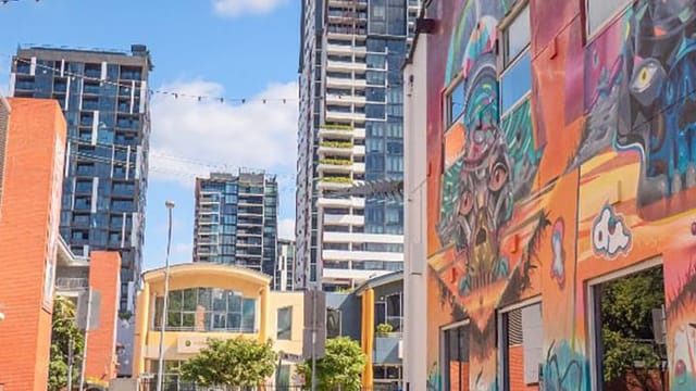Melbourne street with colorful mural and modern buildings
