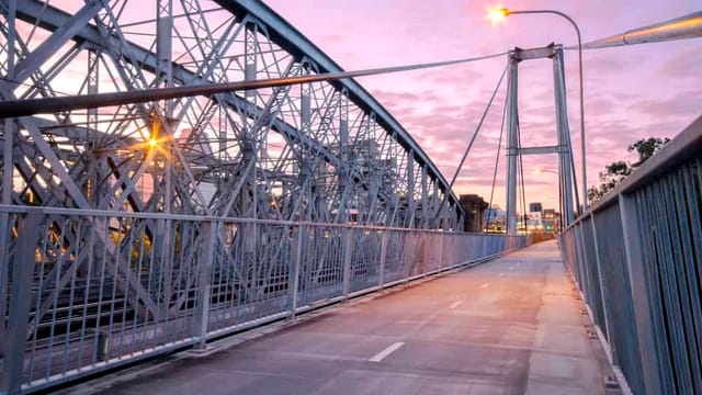 Steel bridge walkway during sunset in Australia.