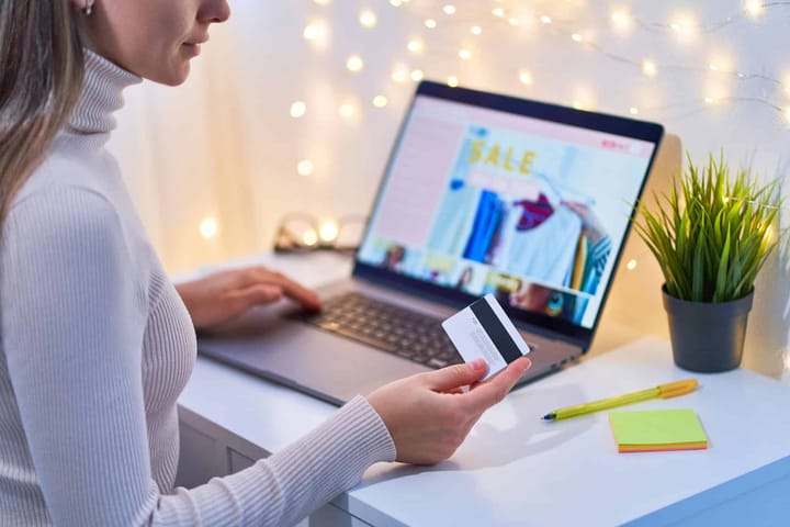 Online shopping with credit card on laptop