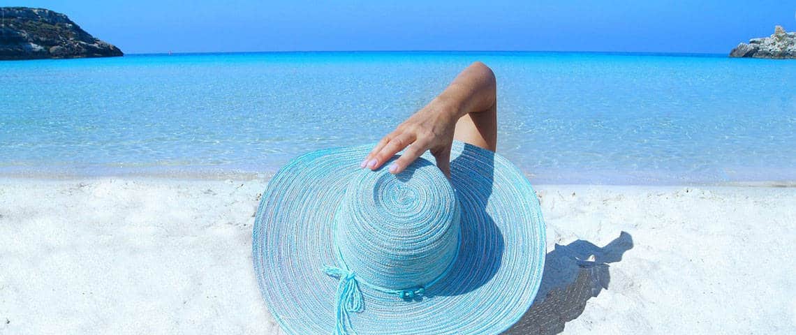 woman wearing a blue hat on the beach