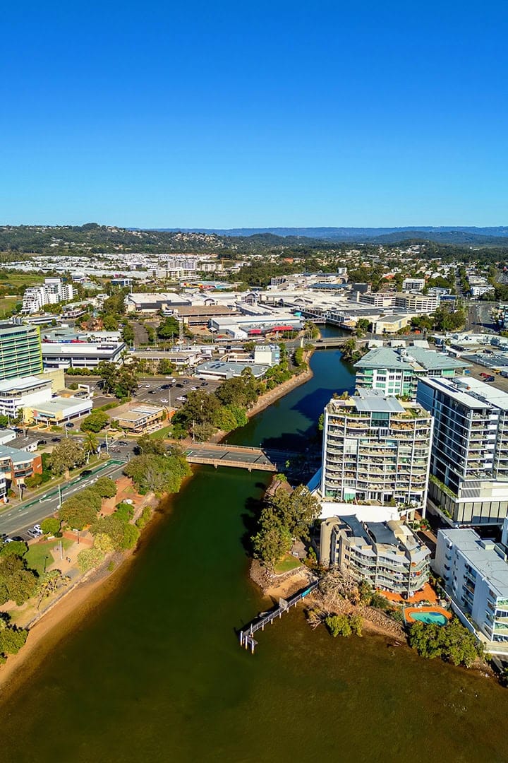 Aerial view of Australian riverside cityscape with clear skies