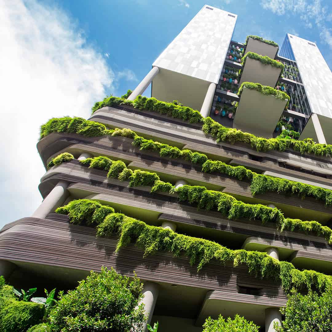 Green-covered high-rise building viewed from below