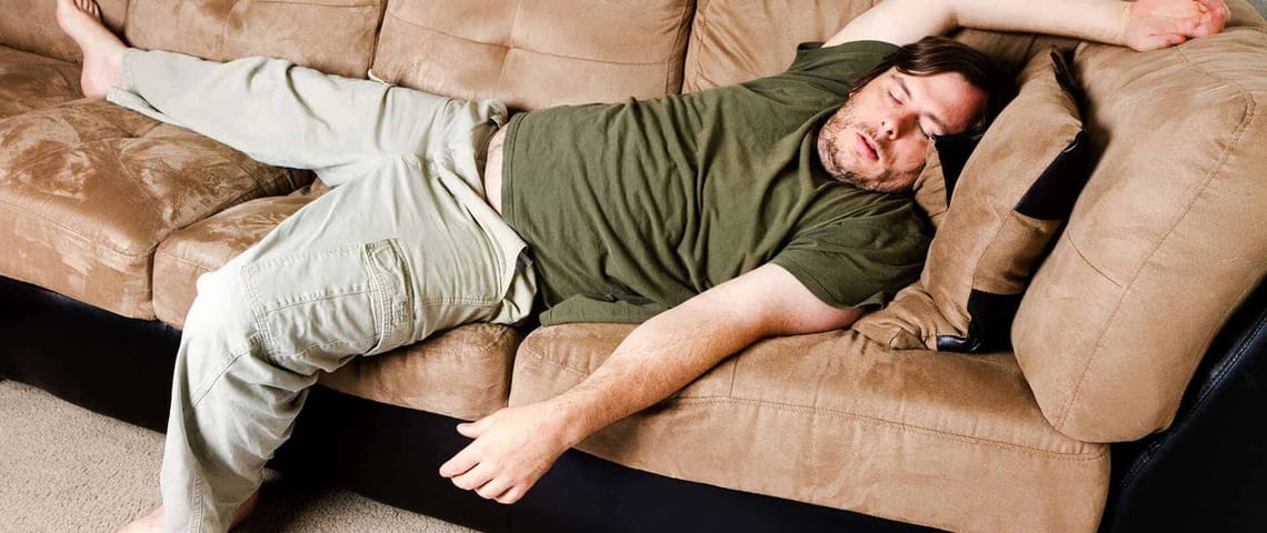 A guy flung all over the couch