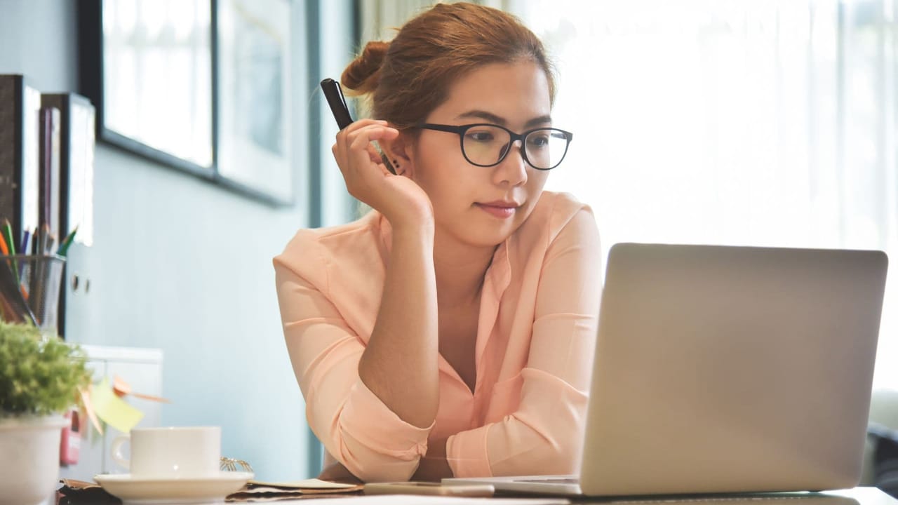 woman working on computer thinking