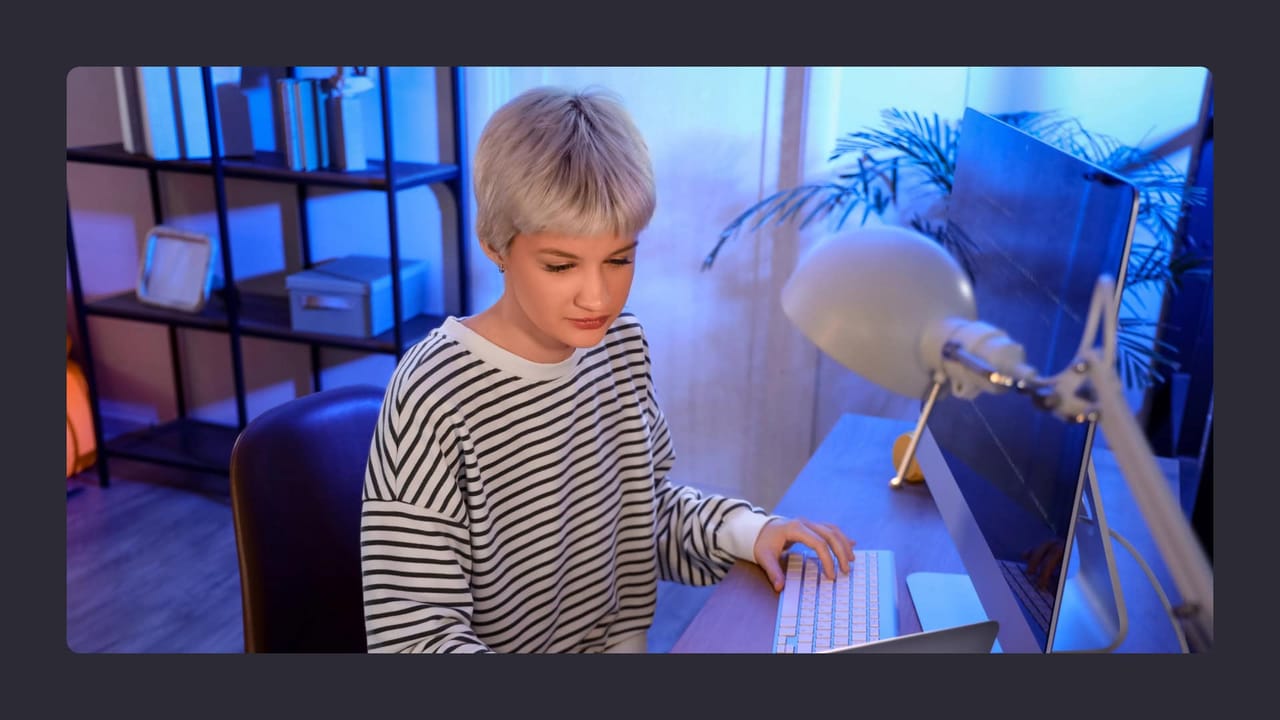 Young woman typing on keyboard in home office