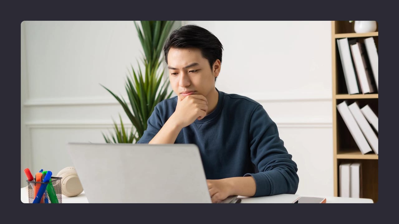 Man focused on laptop in modern study