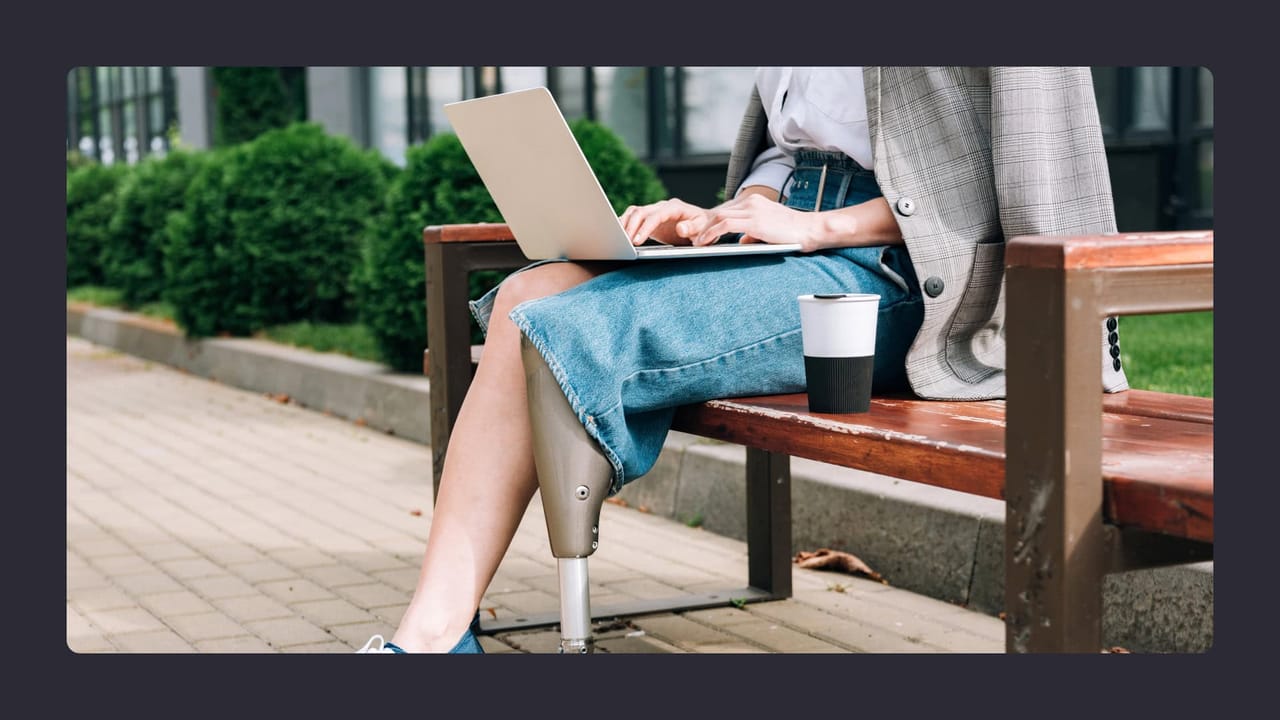 Amputee working on laptop outdoors in Australia