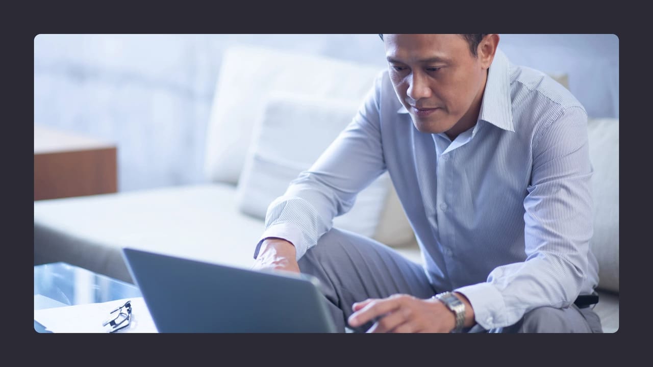 Businessman working on laptop in modern office