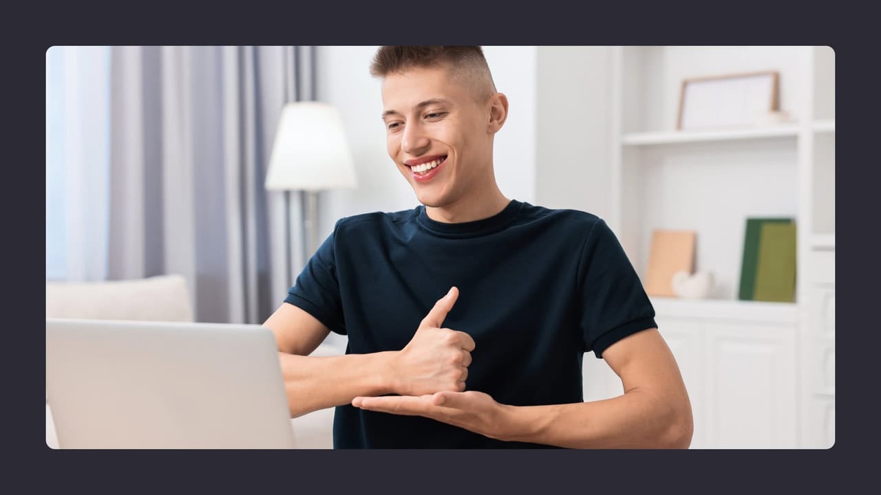 Happy young man using laptop at home