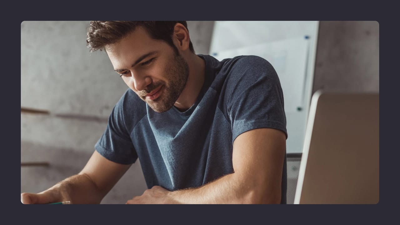 Smiling man using laptop in casual setting