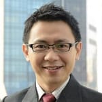 Smiling man in glasses wearing a business suit
