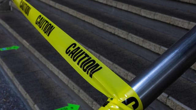 Caution tape blocking stairs for safety.