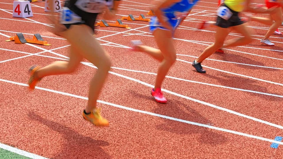 Athletes sprinting on a track during a race