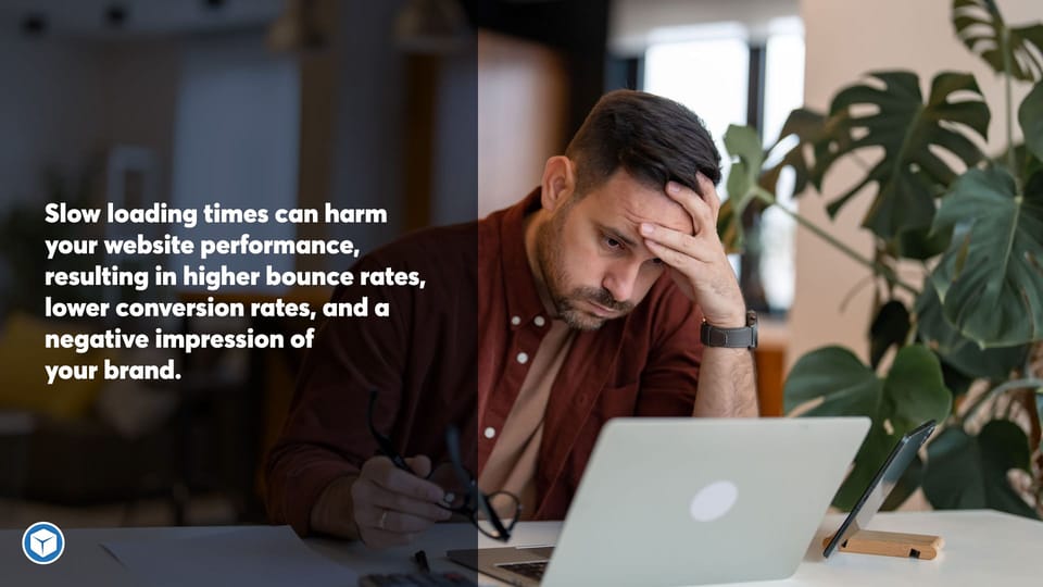 Frustrated man with hands on his head looking at his slow loading website on his laptop.