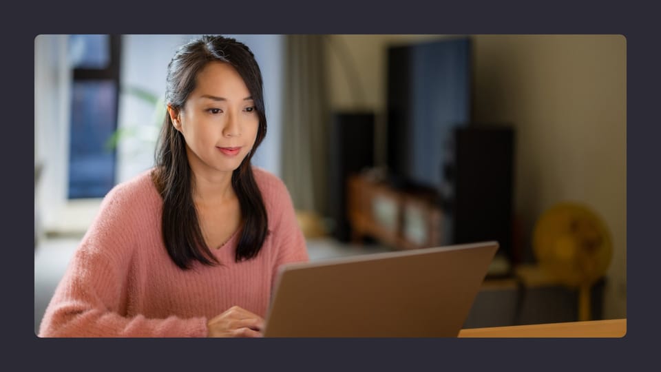 Woman working on laptop at home in Australia