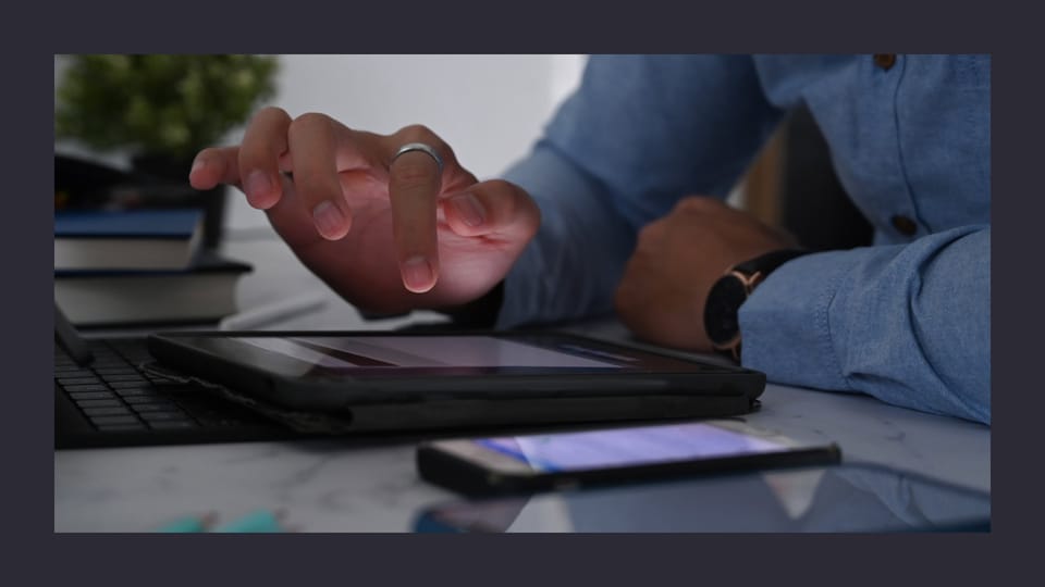 Person using tablet with stylus in office setting