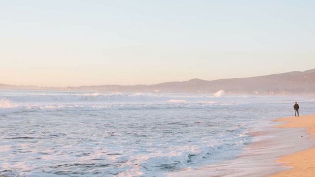 Beach coastline with reddish brown sand