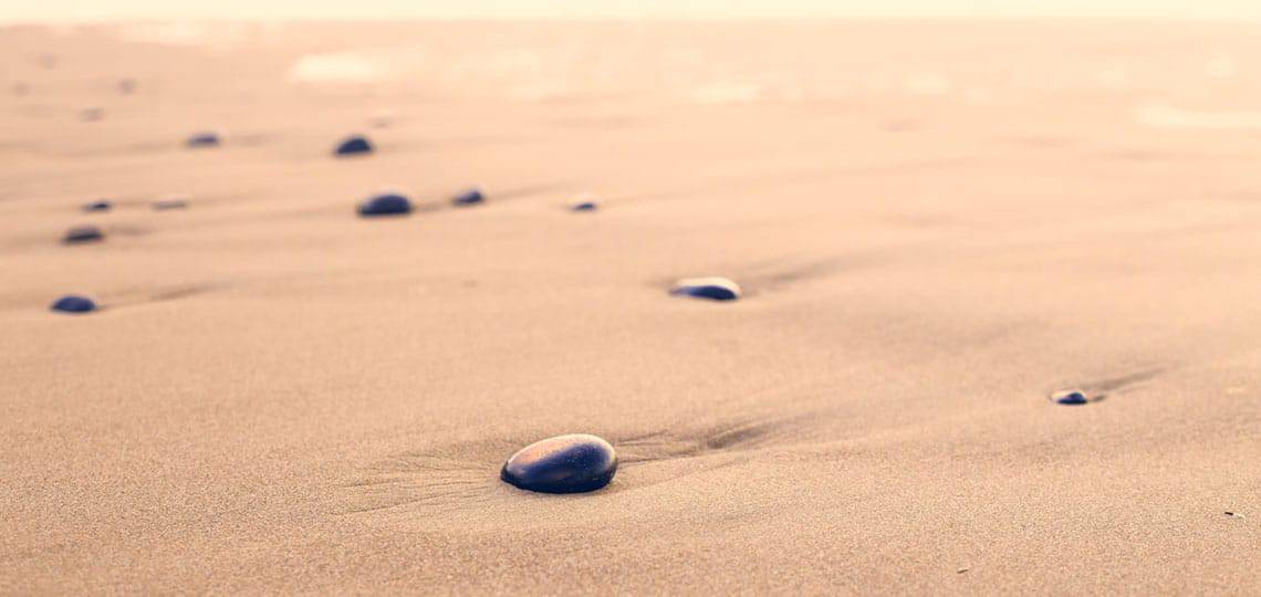 Using-Widgets-in-WordPress Smooth black stones strewn across dessert sands
