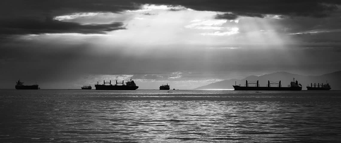 silhouette of cargo ships