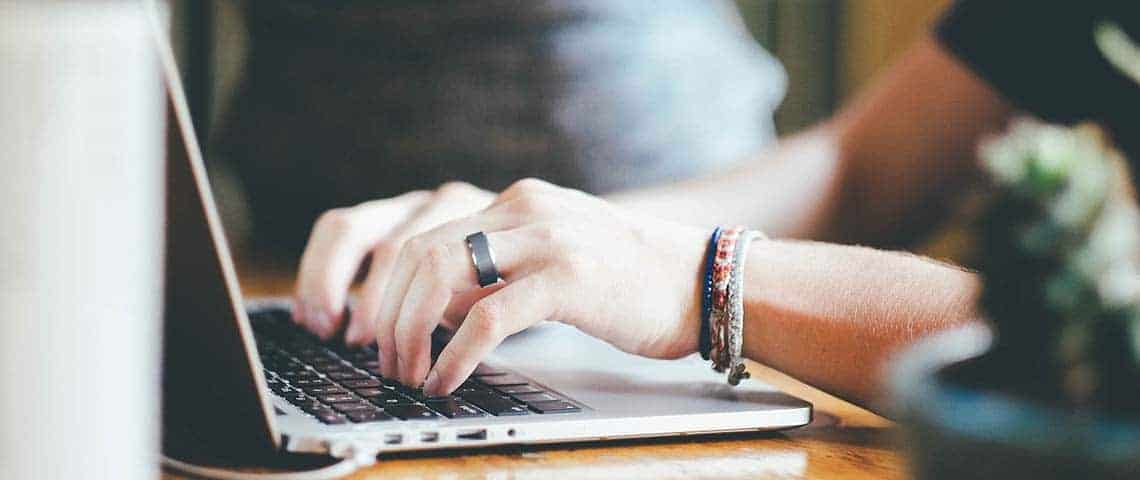 A blogger typing their writing style on a computer