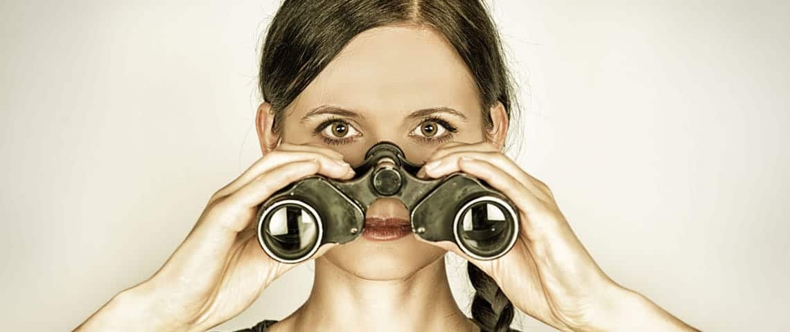 Protecting-Yourself-Against-Negative-SEO A woman with binoculars looking for negative seo