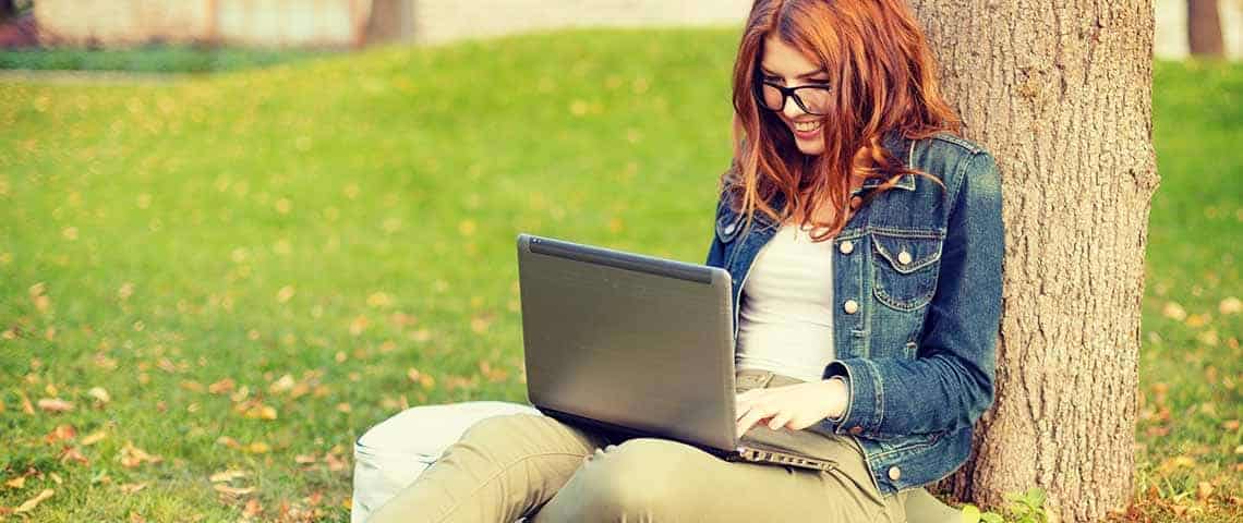 making-your-blog-articles-work-for-you-what-to-do-before-during-and-after-you-post_featured1 a woman writing blog articles at her computer