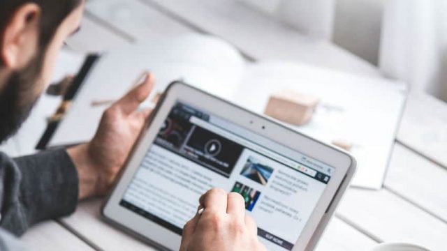 man reading blog on a tablet