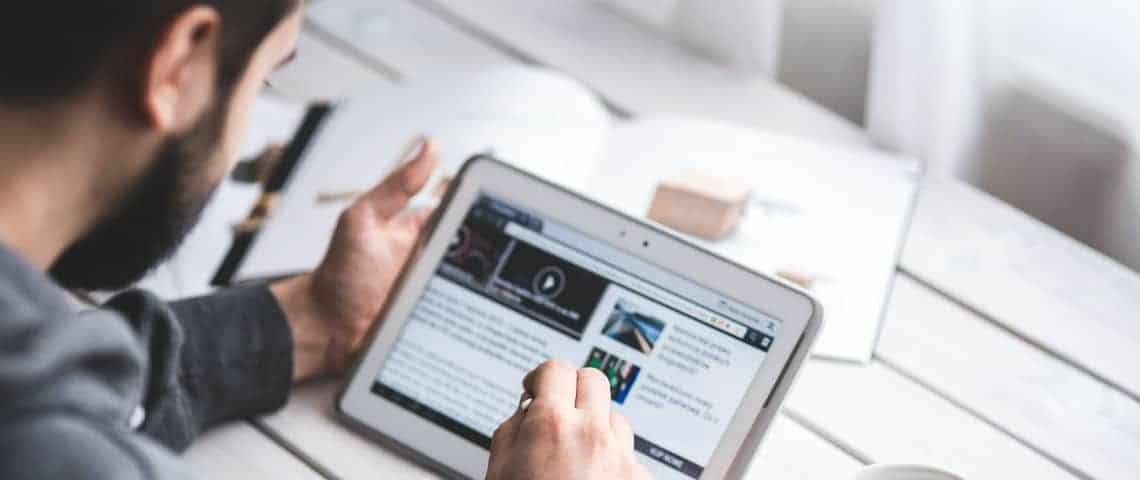 man reading blog on a tablet