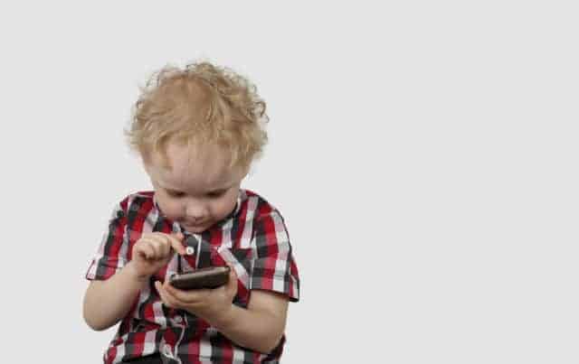 toddler holding a cellphone