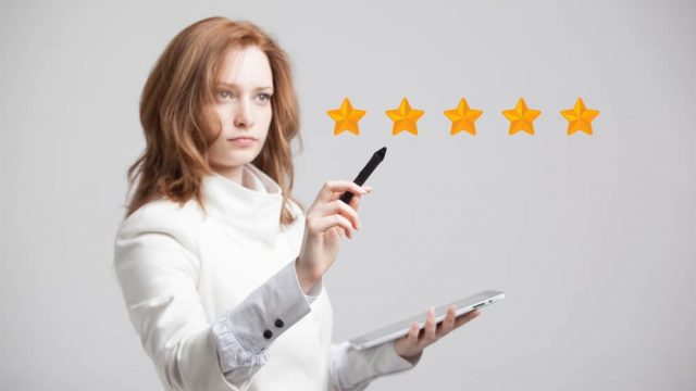 5-star rating, woman assessing service on grey background