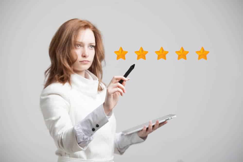 5-star rating, woman assessing service on grey background
