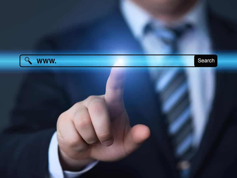 technology, searching system and internet concept - businessman hand pressing Search button www url search bar