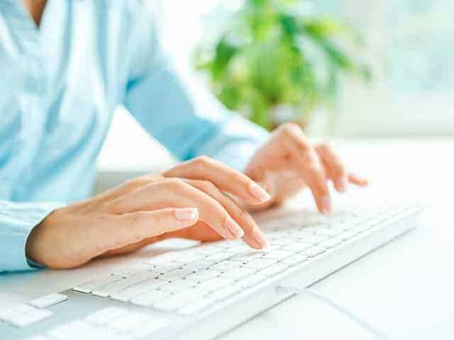 woman typing on keyboard