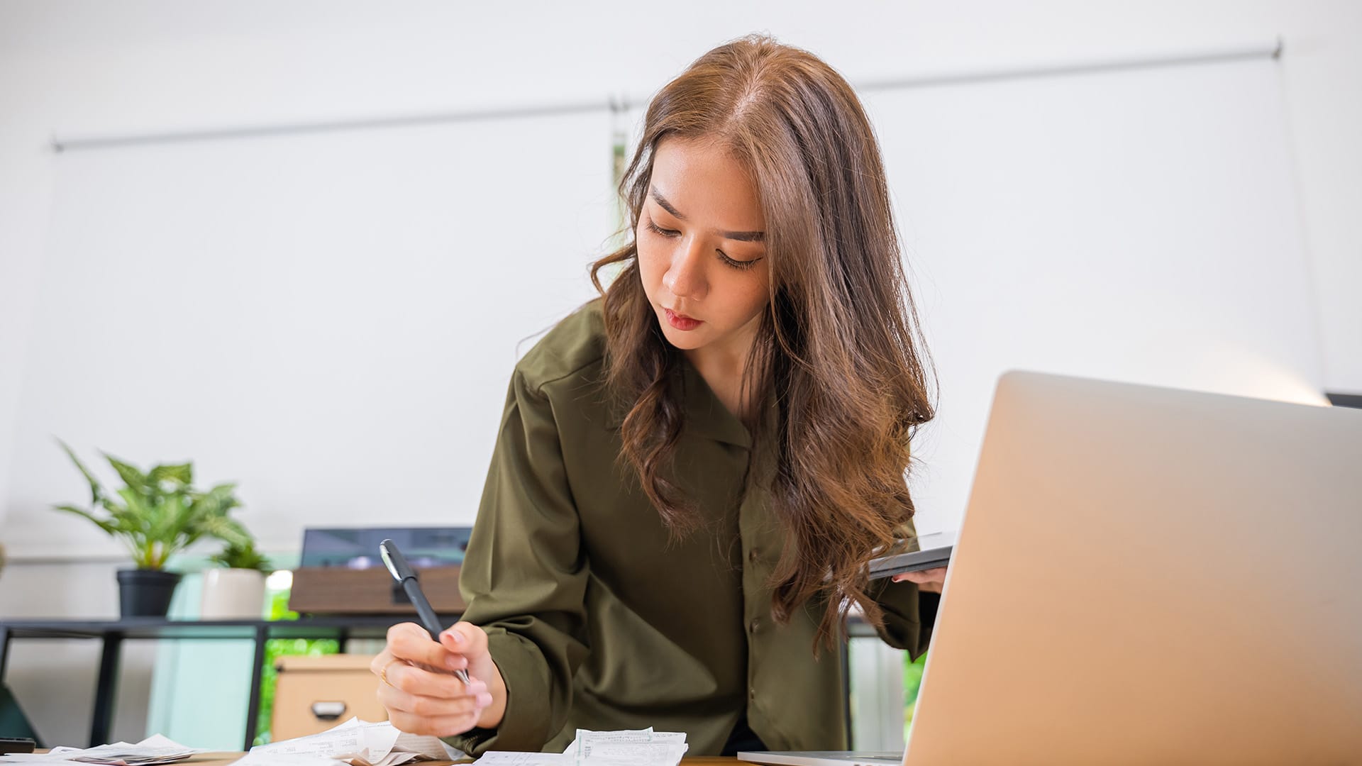 Young asian woman researching how much a website designer costs in Singapore