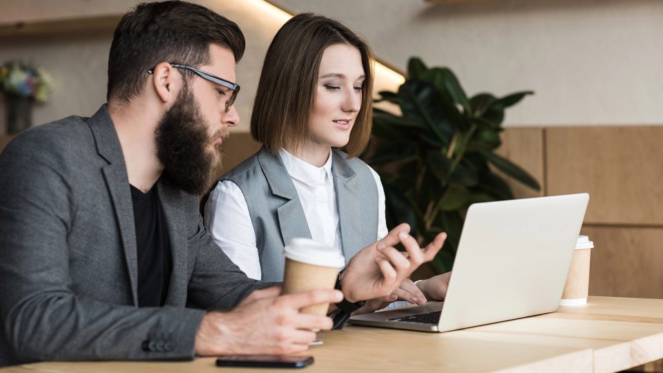 B2B marketing manager reviewing an outdated website layout with her digital team
