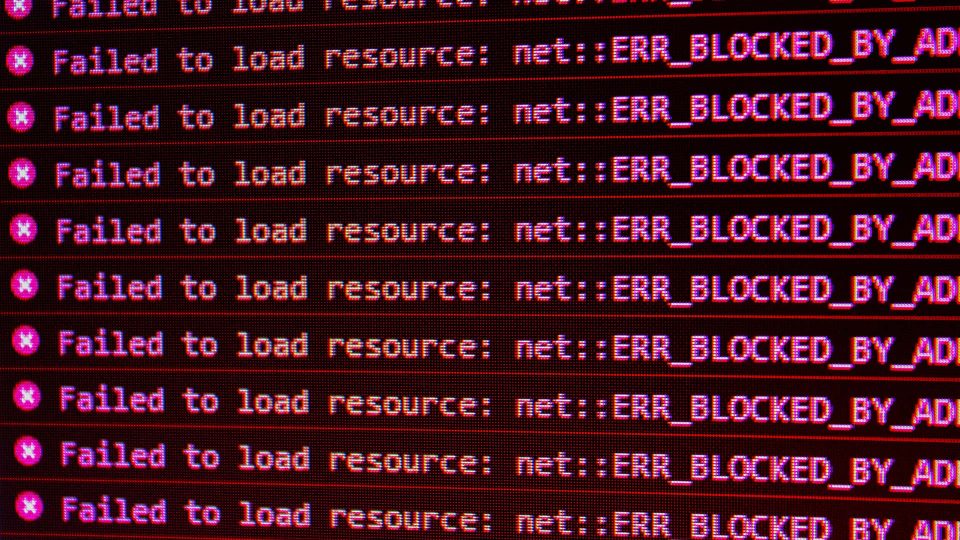 Computer screen showing multiple 'ERR_BLOCKED_BY_AD' messages