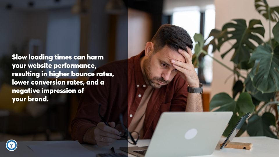 Frustrated man with hands on his head looking at his slow loading website on his laptop.