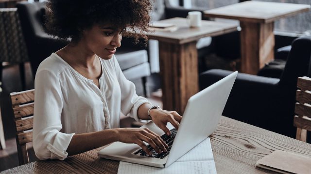 woman working on computer in cafe