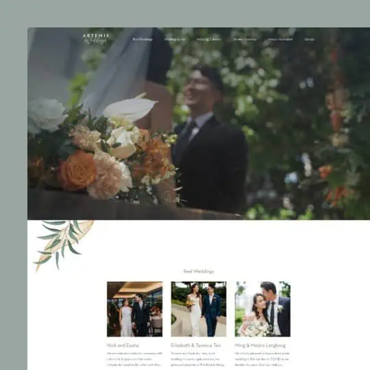 Groom smiling behind elegant wedding floral arrangement