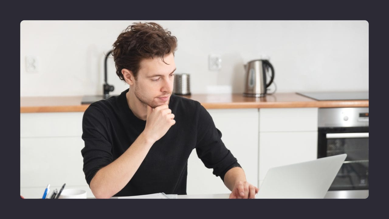 seo web strategy Man pondering at laptop in modern kitchen