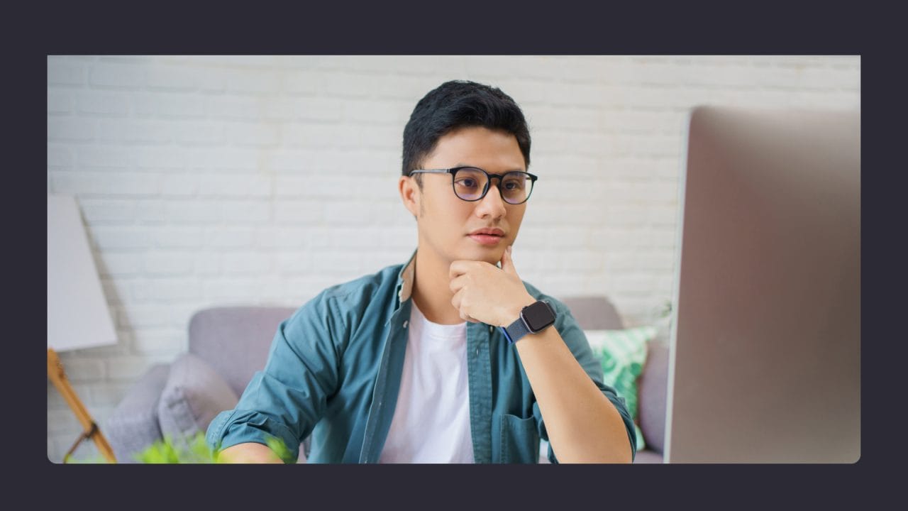 website security checks Young man with glasses using laptop in modern room
