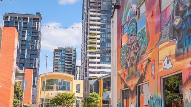 Melbourne street with colorful mural and modern buildings