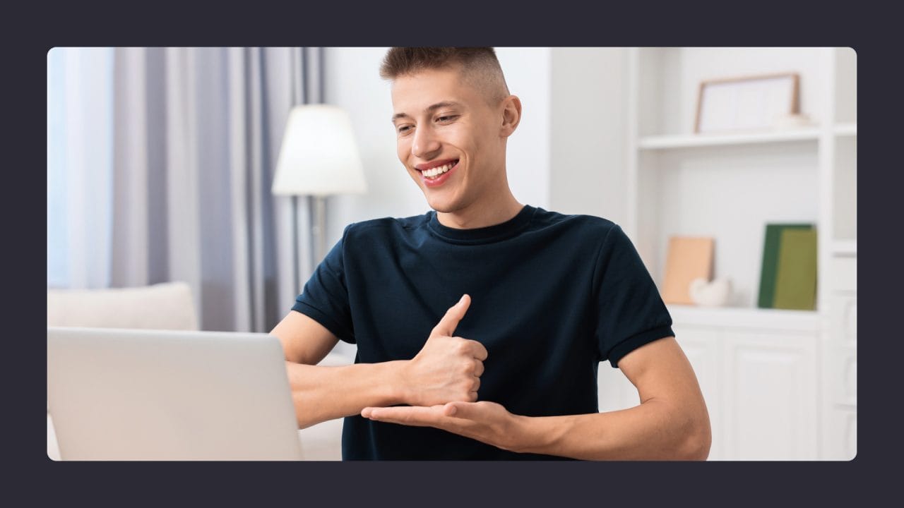 Happy young man using laptop at home