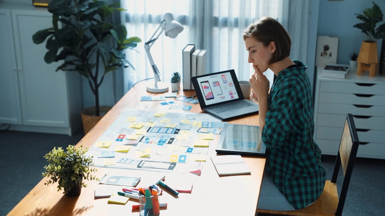 what is ux design Woman designing app interfaces in office workspace