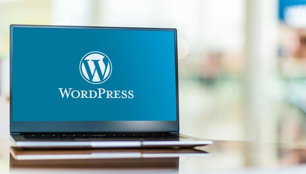 laptop computer displaying logo of wordpress WordPress logo on laptop screen