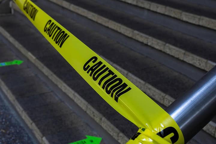 Caution tape blocking stairs for safety.