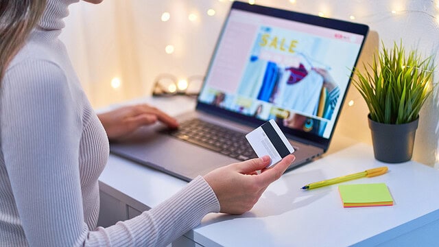 Online shopping with credit card on laptop